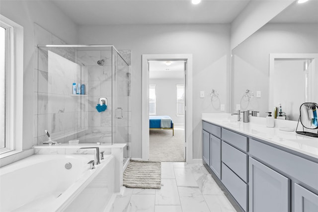 ensuite bathroom featuring marble finish floor, double vanity, a shower stall, and a bath