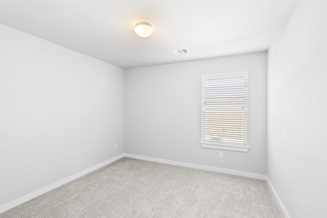 unfurnished room featuring light carpet, visible vents, and baseboards