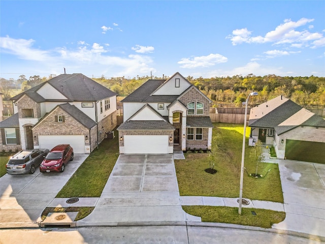 view of front of property featuring roof with shingles, fence, a garage, driveway, and a front lawn