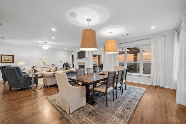 dining area featuring visible vents, recessed lighting, a fireplace, and hardwood / wood-style flooring