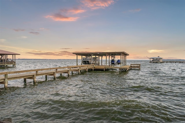 dock area with a water view and boat lift