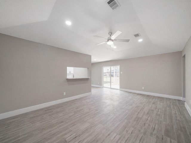 unfurnished room featuring lofted ceiling, ceiling fan, and light hardwood / wood-style flooring