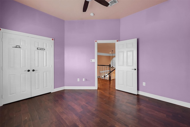 unfurnished bedroom with ceiling fan and dark hardwood / wood-style floors