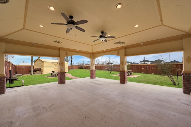 view of patio with a shed and ceiling fan