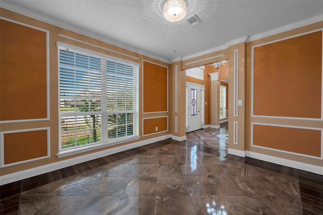 entrance foyer with ornate columns and ornamental molding