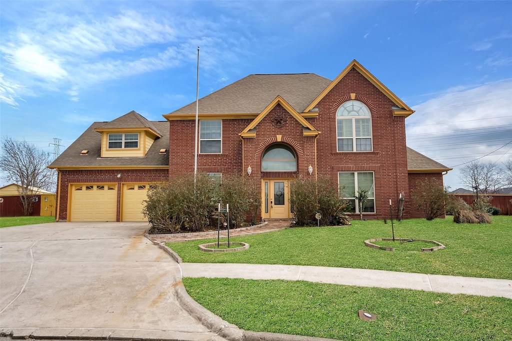 view of front property featuring a garage and a front yard