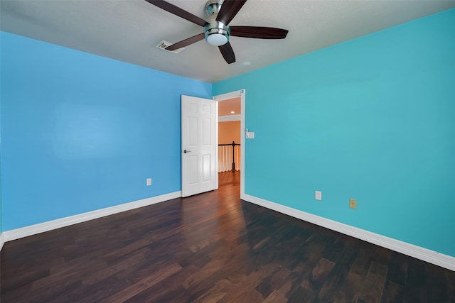 spare room featuring dark hardwood / wood-style floors and ceiling fan