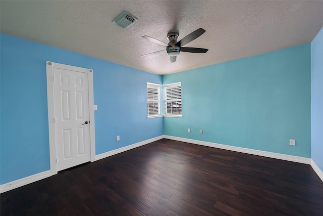 unfurnished room with ceiling fan, dark hardwood / wood-style flooring, and a textured ceiling