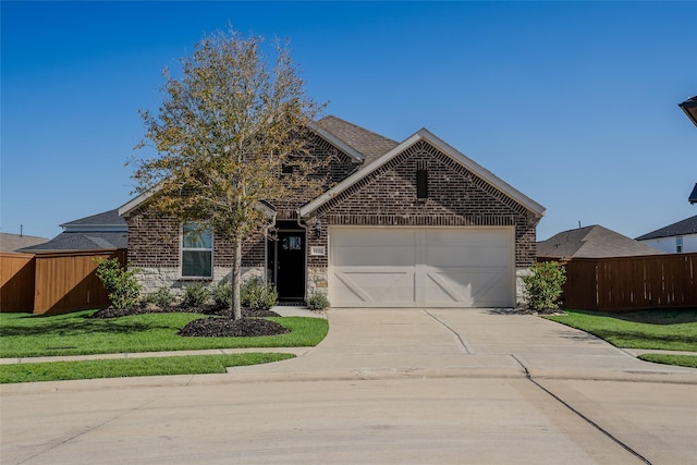 view of front of house featuring a garage and a front lawn