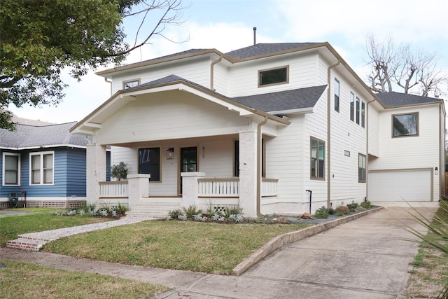 view of front of house with a garage, a front lawn, and covered porch