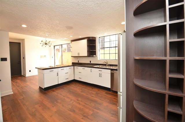 kitchen featuring dark countertops, dark wood-style flooring, a peninsula, and open shelves