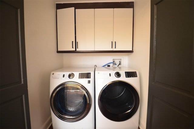 laundry area with cabinets and separate washer and dryer