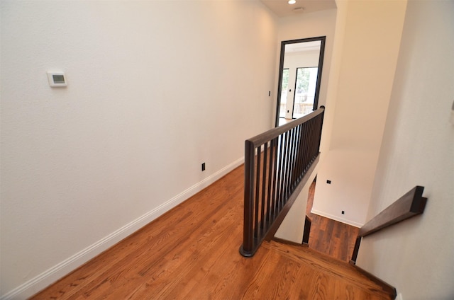 stairway with hardwood / wood-style flooring