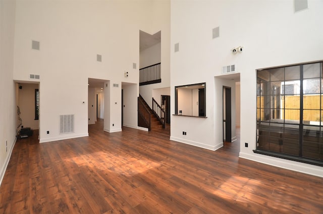 interior space with visible vents, wood finished floors, and stairway