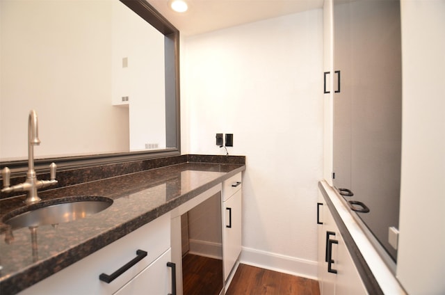 bathroom with recessed lighting, baseboards, wood finished floors, and vanity