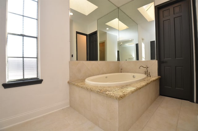 full bath with baseboards, a bath, a skylight, and tile patterned flooring