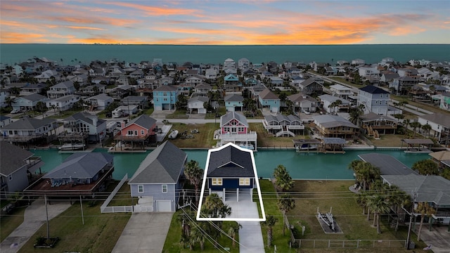 aerial view at dusk with a water view