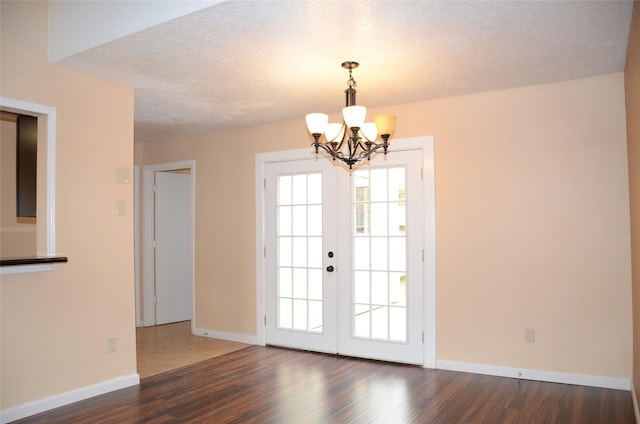 entryway featuring a textured ceiling, dark hardwood / wood-style floors, and a healthy amount of sunlight