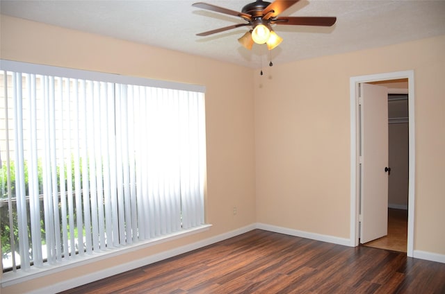 interior space featuring ceiling fan, a textured ceiling, and dark hardwood / wood-style flooring