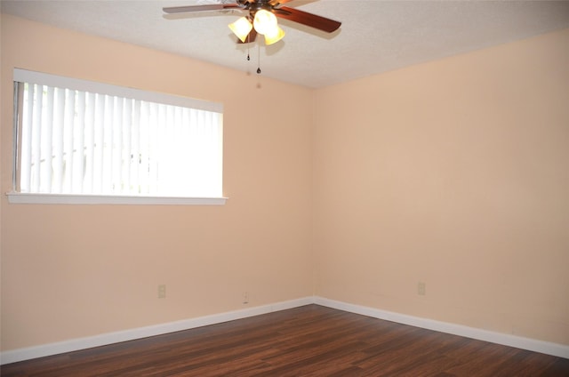 unfurnished room with dark wood-type flooring and ceiling fan