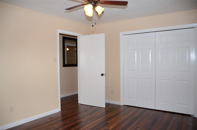 unfurnished bedroom with a closet, dark hardwood / wood-style floors, a textured ceiling, and ceiling fan