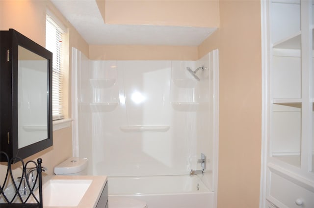 full bathroom with vanity, a textured ceiling, washtub / shower combination, and toilet