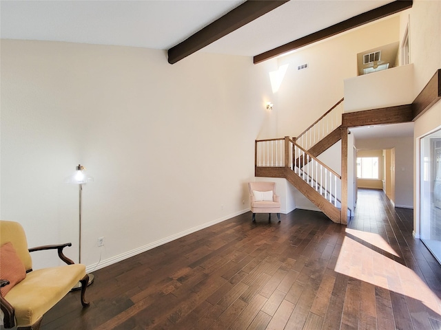 living area with visible vents, baseboards, dark wood-style flooring, beamed ceiling, and stairs