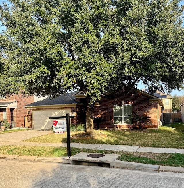 view of front of property featuring a garage and a front lawn