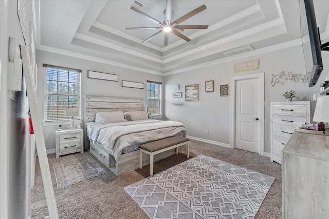 carpeted bedroom featuring ornamental molding, ceiling fan, and a tray ceiling