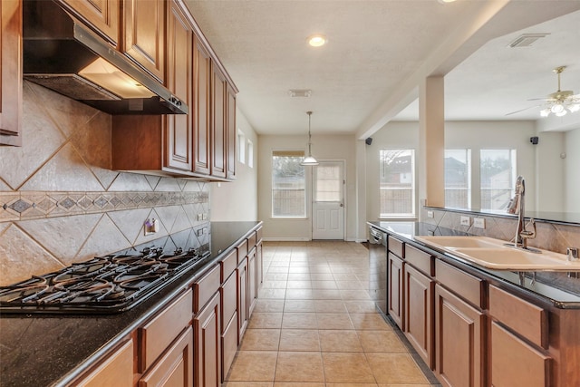 kitchen featuring sink, tasteful backsplash, light tile patterned floors, appliances with stainless steel finishes, and ceiling fan