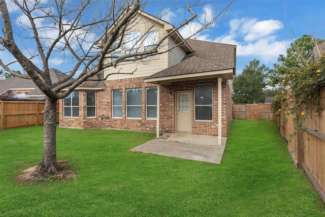 rear view of property featuring a yard and a patio