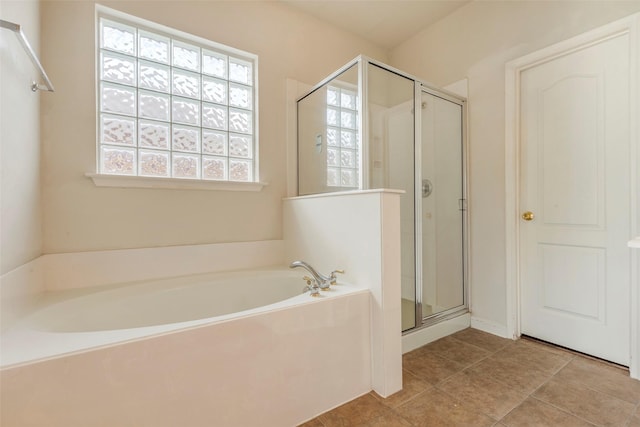 bathroom featuring tile patterned flooring and separate shower and tub