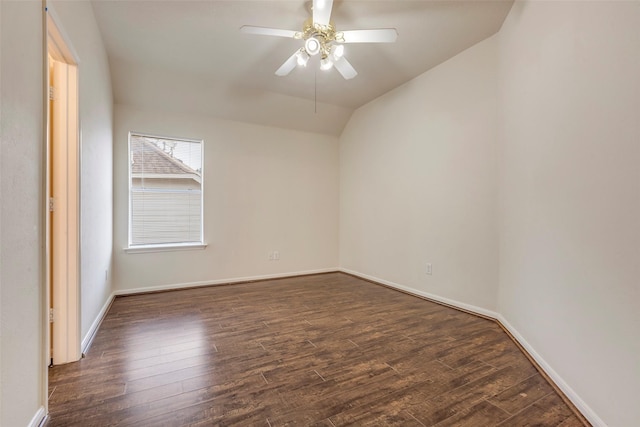 empty room with lofted ceiling, dark hardwood / wood-style floors, and ceiling fan