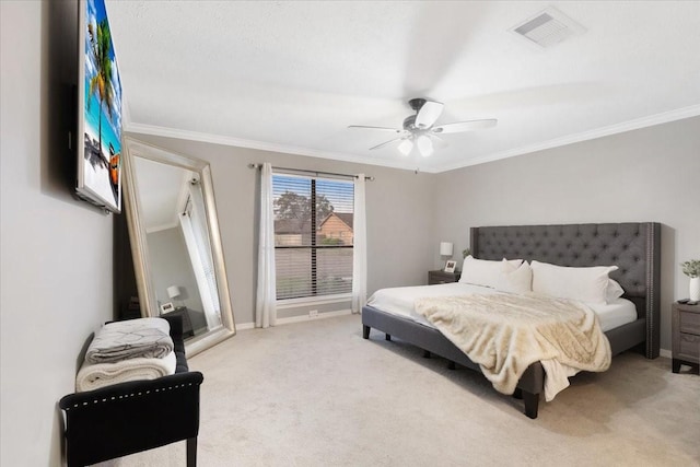 carpeted bedroom with ornamental molding and ceiling fan