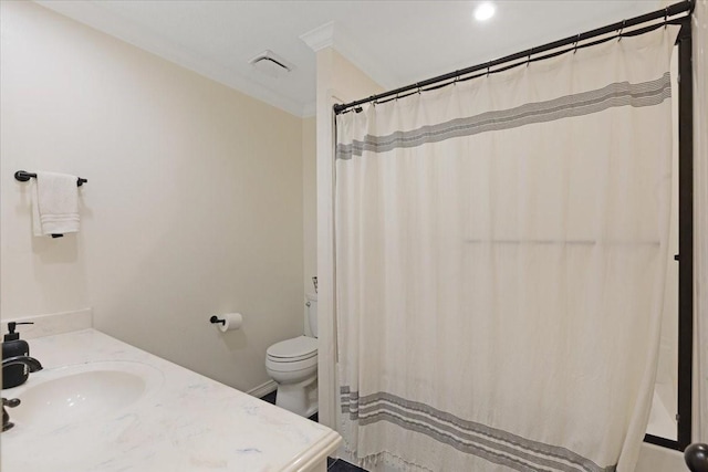 bathroom with ornamental molding, vanity, and toilet