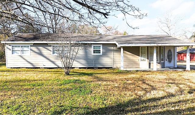 back of house with a lawn