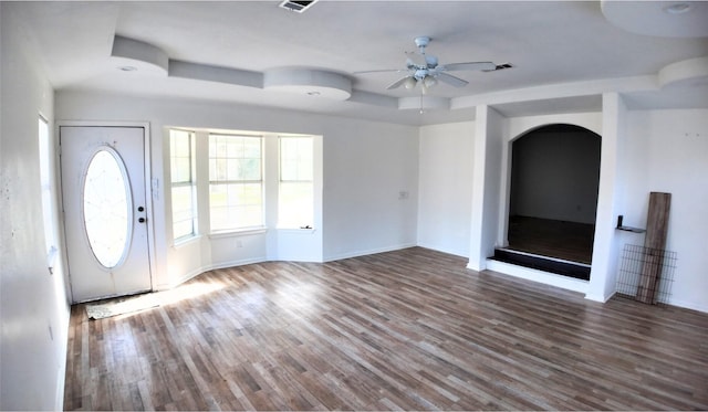 foyer with ceiling fan, dark hardwood / wood-style flooring, and a tray ceiling