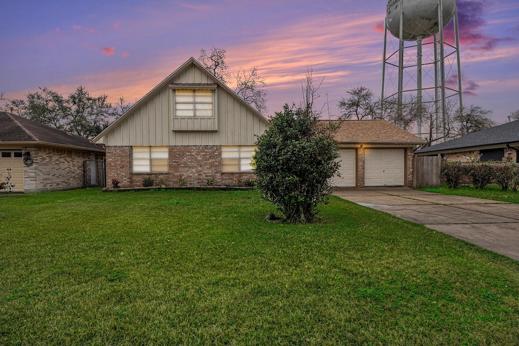 view of front of home featuring a garage and a yard