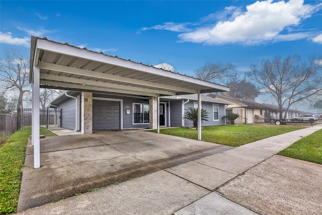 ranch-style house featuring a garage, a front lawn, and a carport