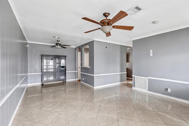 unfurnished room featuring light tile patterned floors, crown molding, and ceiling fan