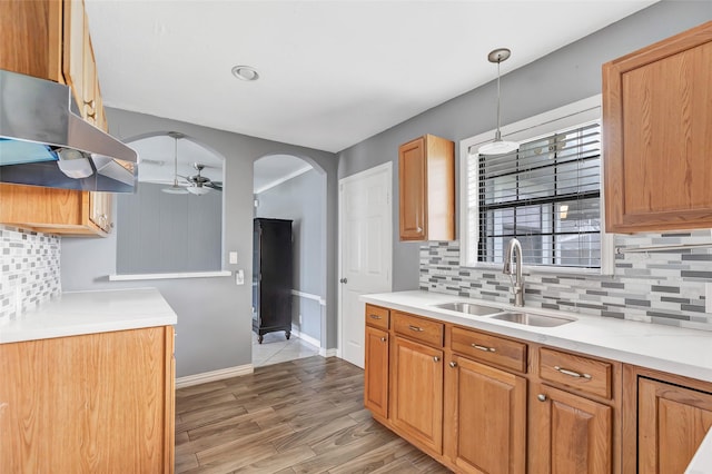 kitchen featuring tasteful backsplash, sink, pendant lighting, and ceiling fan