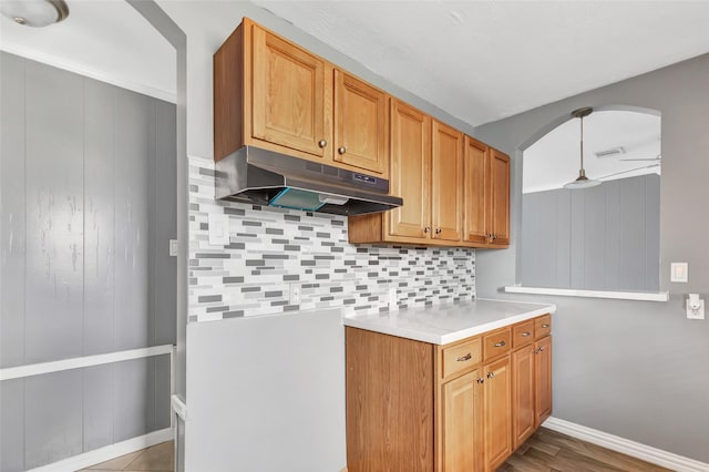 kitchen with wood-type flooring, pendant lighting, and decorative backsplash