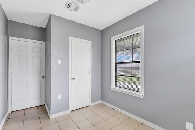 unfurnished bedroom featuring light tile patterned flooring