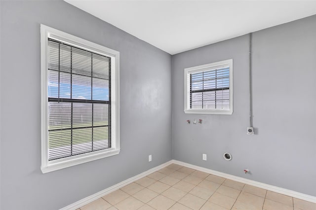 tiled empty room featuring plenty of natural light