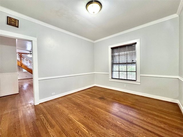 spare room with hardwood / wood-style flooring and crown molding