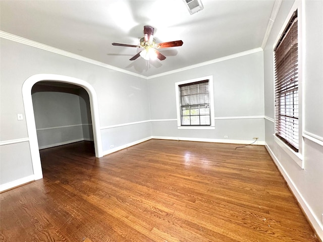 unfurnished room with hardwood / wood-style floors, crown molding, and ceiling fan