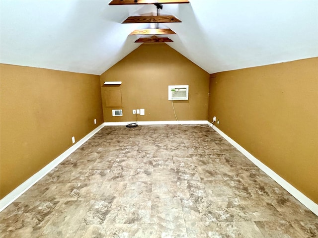 additional living space featuring lofted ceiling