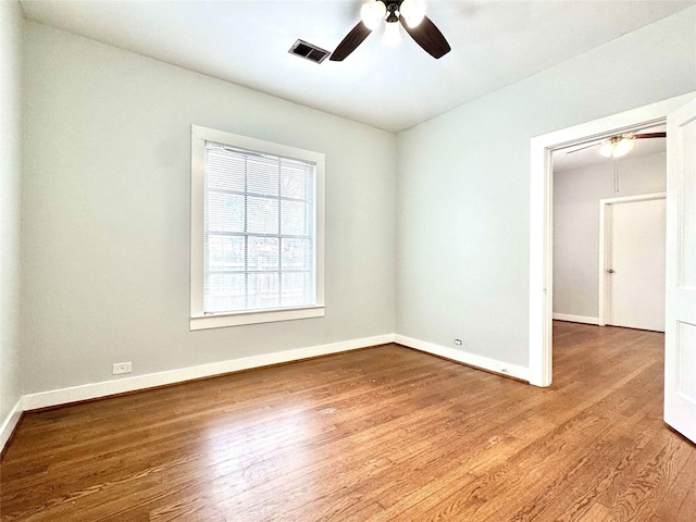 unfurnished room featuring hardwood / wood-style floors and ceiling fan