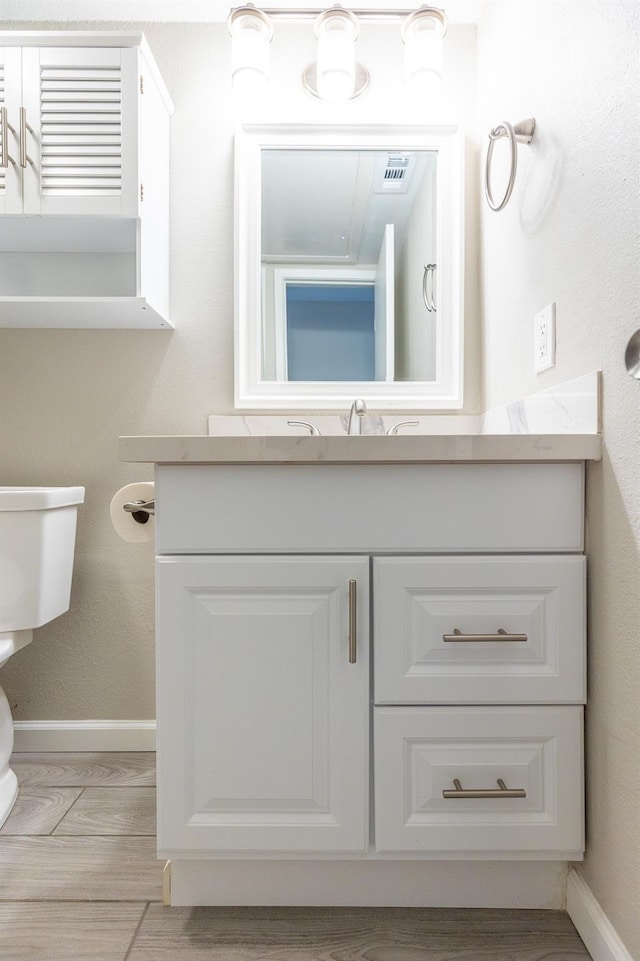 bathroom with vanity and toilet