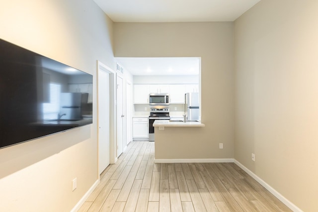 kitchen featuring appliances with stainless steel finishes and white cabinets